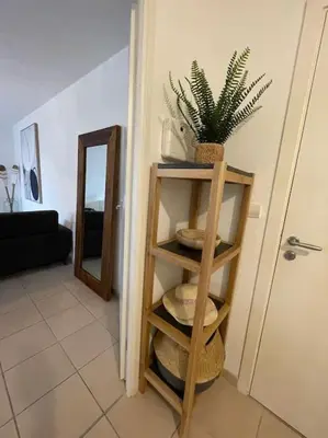 a room with a plant on a shelf next to a door at Confortable and Cozy in Vinassan