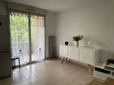 a living room with a large window and white furniture at Confortable and Cozy in Vinassan
