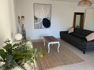 a living room with a couch and a table at Confortable and Cozy in Vinassan