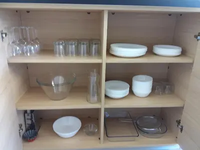 a wooden cabinet filled with bowls and glassware at Chalet 3 chambres, piscine, lac à 100m - Olonzac - FR-1-783-1 in Olonzac