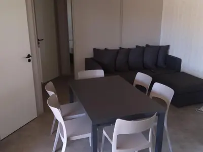a living room with a black table and white chairs at Chalet 3 chambres, piscine, lac à 100m - Olonzac - FR-1-783-1 in Olonzac