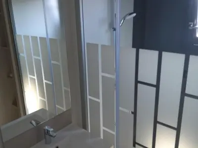 a bathroom with a shower with a glass door at Chalet 3 chambres, piscine, lac à 100m - Olonzac - FR-1-783-1 in Olonzac