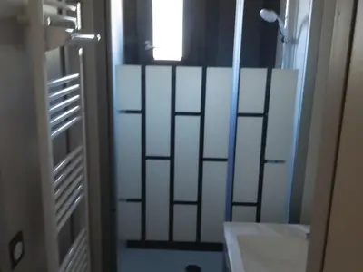 a bathroom with a door with a sink and a mirror at Chalet 3 chambres, piscine, lac à 100m - Olonzac - FR-1-783-1 in Olonzac