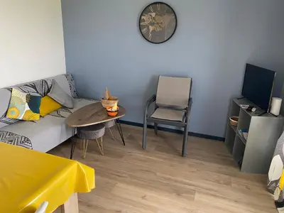 a living room with a couch and a table and a chair at Chalet confortable 2 chambres près du lac de Jouarres - FR-1-783-8 in Olonzac