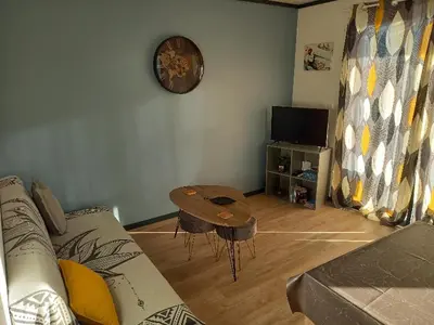 a living room with a couch and a table at Chalet confortable 2 chambres près du lac de Jouarres - FR-1-783-8 in Olonzac