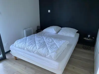 a bed with white sheets and pillows in a bedroom at Chalet confortable 2 chambres près du lac de Jouarres - FR-1-783-8 in Olonzac