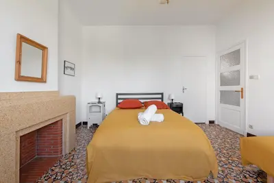 a bedroom with a bed and a fireplace at la Voûte in Carcassonne
