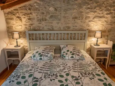 a bedroom with a white bed with two night stands at Le Pigeonnier de Villefloure in Montréal