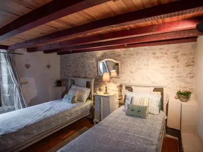 a bedroom with two beds and a mirror at Le Pigeonnier de Villefloure in Montréal