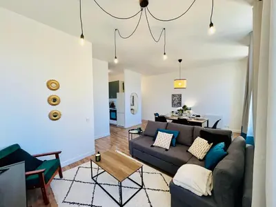 a living room with a couch and a table at Appartement Chez Rose in Narbonne
