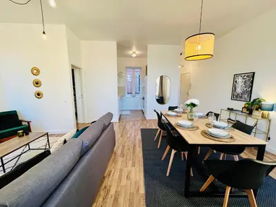 a living room with a couch and a table at Appartement Chez Rose in Narbonne