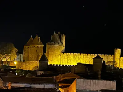 a white table and chairs sitting on a patio at la porte medievale in Carcassonne