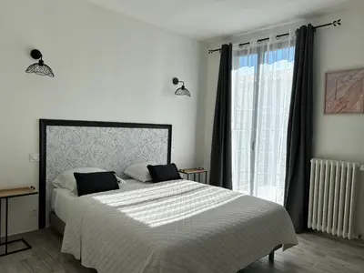 a living room with a leather couch and a table at la porte medievale in Carcassonne
