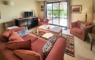 a living room with two couches and a table at Awesome Home In Saint-Laurent-De-La-Ca in Saint-Laurent-de-la-Cabrerisse
