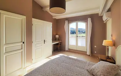 a bedroom with a bed and a window and a desk at Awesome Home In Saint-Laurent-De-La-Ca in Saint-Laurent-de-la-Cabrerisse