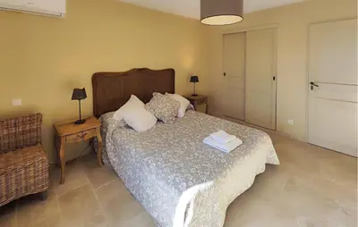 a bedroom with a bed with two towels on it at Awesome Home In Saint-Laurent-De-La-Ca in Saint-Laurent-de-la-Cabrerisse
