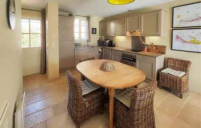 a kitchen with a wooden table and chairs at Awesome Home In Saint-Laurent-De-La-Ca in Saint-Laurent-de-la-Cabrerisse