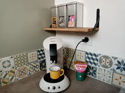 a coffee maker on a counter in a kitchen with tiles at Cozy self contained modern home near Carcassonne in Badens