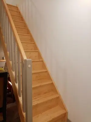 a set of stairs in a room with white walls at Cozy self contained modern home near Carcassonne in Badens