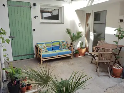 a blue couch sitting on a patio with a table at Cozy self contained modern home near Carcassonne in Badens