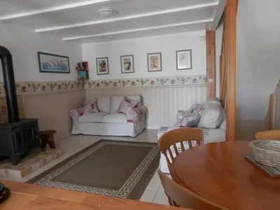 a living room with two white couches and a table at Maison de Laura in Salsigne