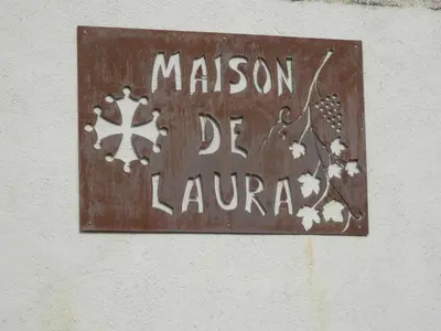 a sign on a wall that says mission de la lena at Maison de Laura in Salsigne