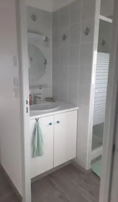 a white bathroom with a sink and a mirror at Gîte avec piscine - 4 personnes - Pays Cathare in Cuxac-Cabardès