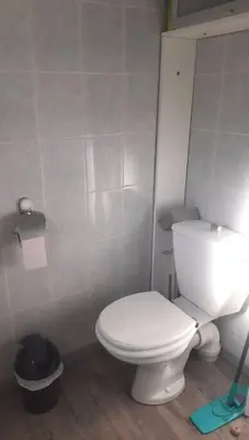 a bathroom with a white toilet and a trash can at Gîte avec piscine - 4 personnes - Pays Cathare in Cuxac-Cabardès