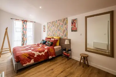 a bedroom with a bed and a large mirror at Oasis Urbaine Narbonne in Narbonne