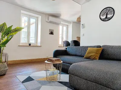 a living room with a couch and a table at Le Iéna in Carcassonne
