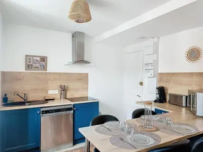 a kitchen with a table with wine glasses on it at Le Iéna in Carcassonne