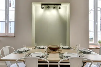 a dining room with a table with chairs and a mirror at Le Coste - Free parking - Central - Wifi -netflix in Carcassonne