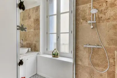 a bathroom with a shower with a tub and a sink at Le Coste - Free parking - Central - Wifi -netflix in Carcassonne