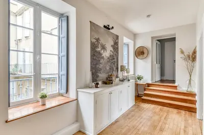 a hallway with white walls and windows and a staircase at Le Coste - Free parking - Central - Wifi -netflix in Carcassonne