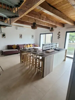 a kitchen and living room with a table and chairs at BEAU T3 AU COEUR DU CENTRE VILLE (205) in Narbonne