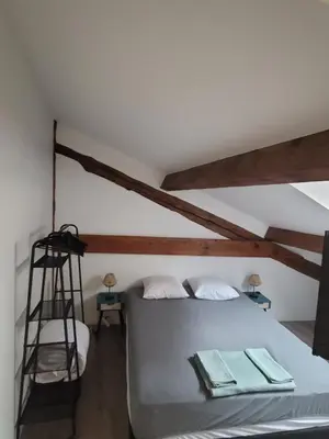 a bedroom with a white bed and a ladder at BEAU T3 AU COEUR DU CENTRE VILLE (205) in Narbonne