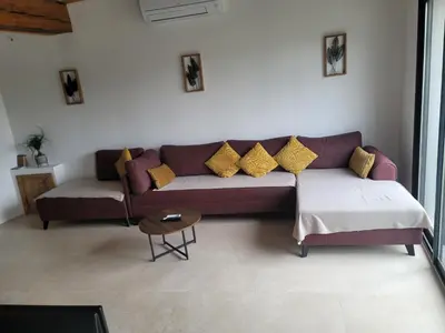 a living room with a purple couch with yellow pillows at BEAU T3 AU COEUR DU CENTRE VILLE (205) in Narbonne