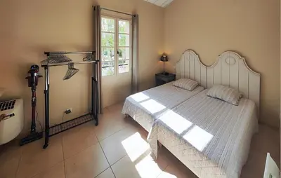 a bedroom with a large bed and a window at Pet Friendly Home In Saint-Laurent-De-La-Ca in Saint-Laurent-de-la-Cabrerisse