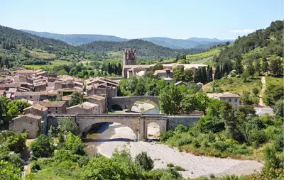 a small village with a bridge and a river at Pet Friendly Home In Saint-Laurent-De-La-Ca in Saint-Laurent-de-la-Cabrerisse