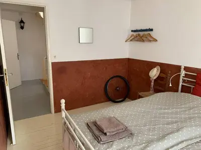 a bedroom with a bed with a bike on the wall at Townhouse in Southern France with a wonderful view and close to a Swimming pool in Axat