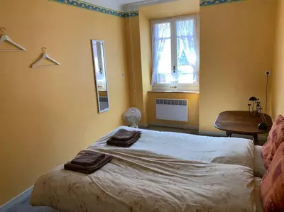 a bedroom with a bed with two towels on it at Townhouse in Southern France with a wonderful view and close to a Swimming pool in Axat