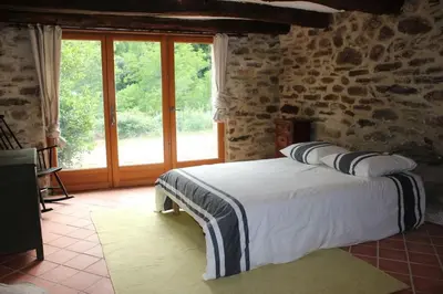 a bedroom with a bed and a large window at LE JARDIN DEL SUD in Saint-Vincent