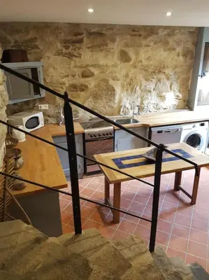 a kitchen with a counter and a table in a room at LE JARDIN DEL SUD in Saint-Vincent