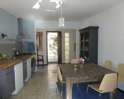 a kitchen with a wooden table and a dining room at LE JARDIN DEL SUD in Saint-Vincent