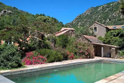 a house with a swimming pool in front of a mountain at LE JARDIN DEL SUD in Saint-Vincent