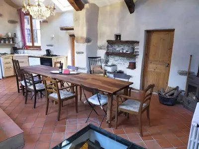 a dining room with a wooden table and chairs at LE JARDIN DEL SUD in Saint-Vincent