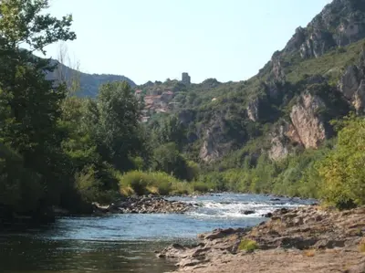 a river with a mountain in the background at LE JARDIN DEL SUD in Saint-Vincent