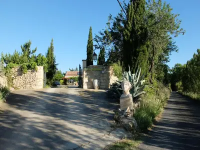 a street with a statue on the side of a road at LA LAVANDIERE Famille Amis Relais Motards in Peyriac-de-Mer