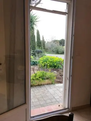 an open window with a view of a garden at LA LAVANDIERE Famille Amis Relais Motards in Peyriac-de-Mer