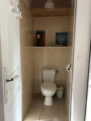 a bathroom with a toilet in a small room at LA LAVANDIERE Famille Amis Relais Motards in Peyriac-de-Mer